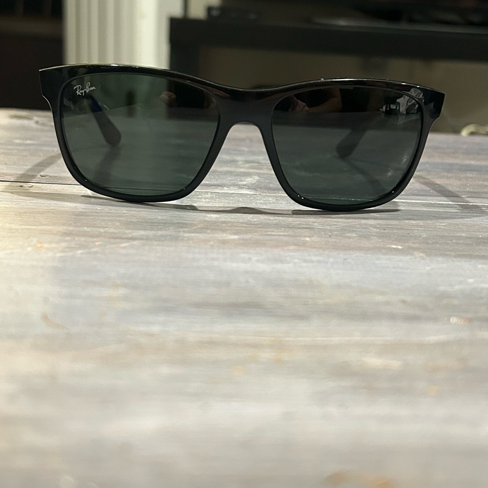 Ray-Ban sunglasses. Black frames with dark grey lenses.